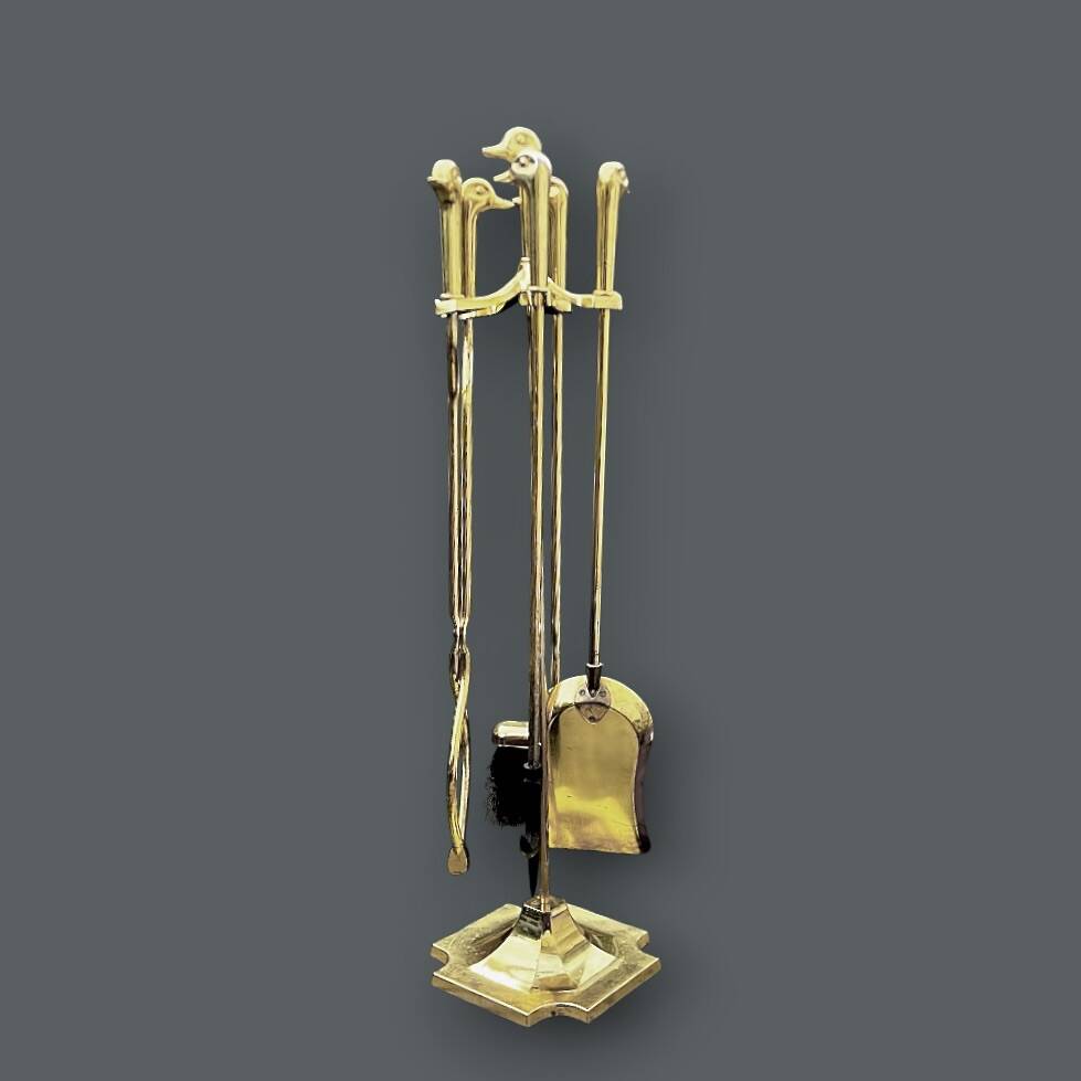 Antique fireplace tool in gilded zamak with duck head designs.