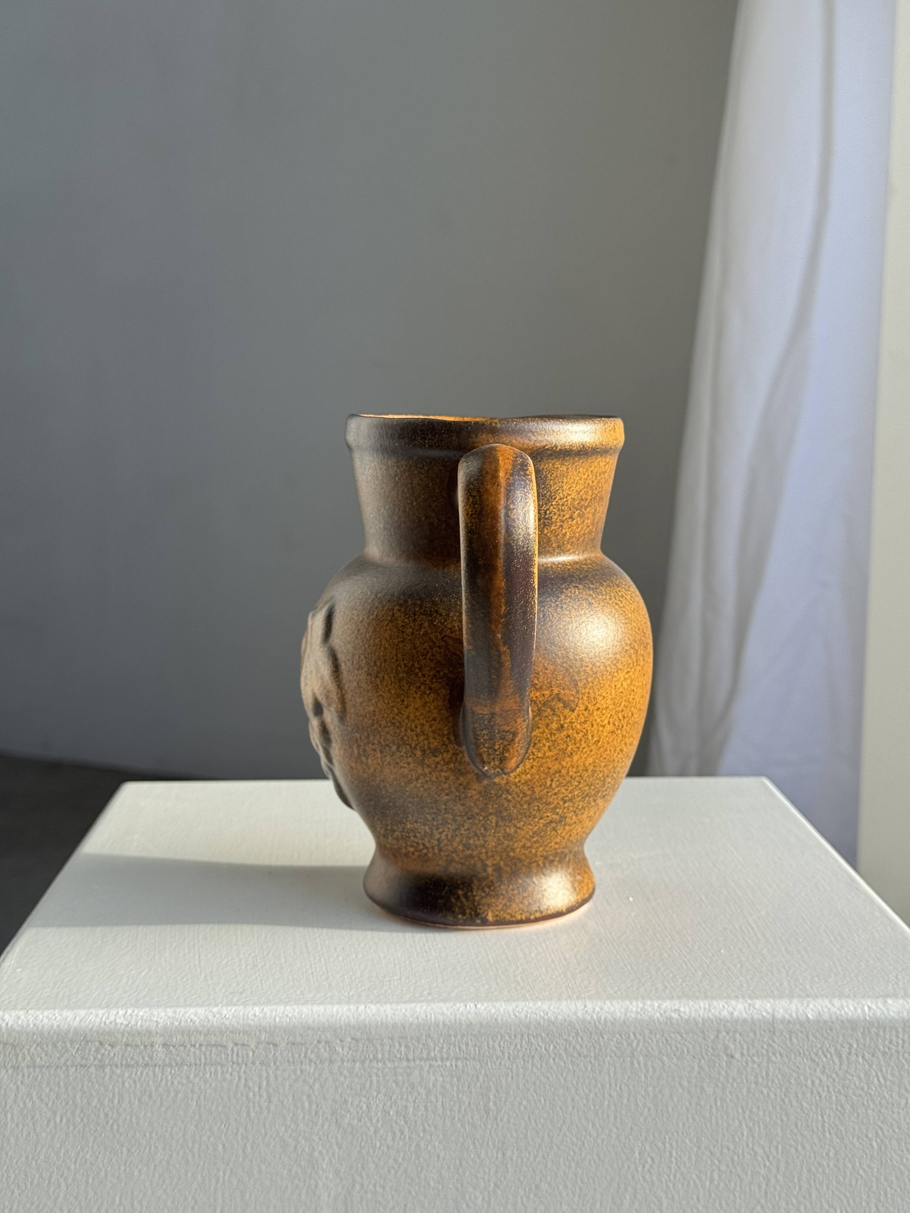 Speckled stoneware jug with grape pattern H17