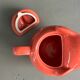 Large coral-coloured elephant teapot.