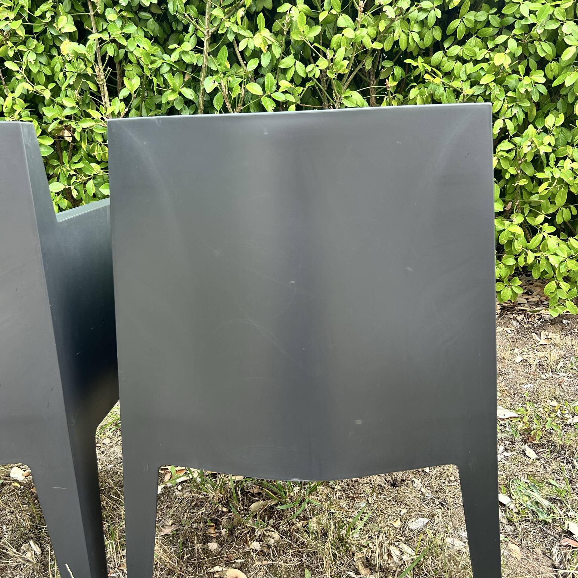 2 black Toy chairs designed by Starck