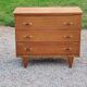Vintage chest of drawers in golden oak from the 50s with 3 drawers and spindle-legged shelf