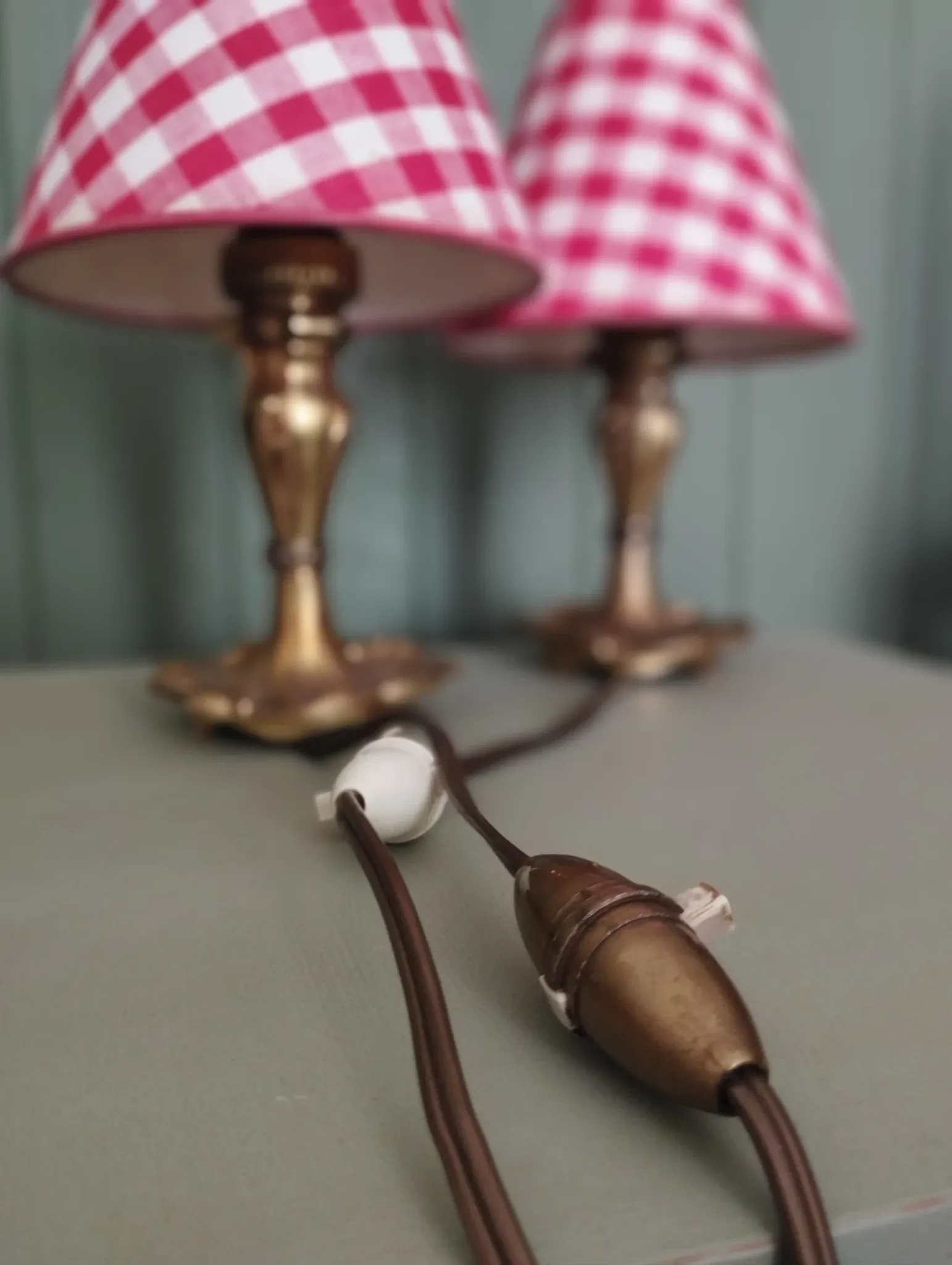 Pair of small lamps in gilded bronze by Petitot and red gingham lampshades.
