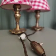 Pair of small lamps in gilded bronze by Petitot and red gingham lampshades.