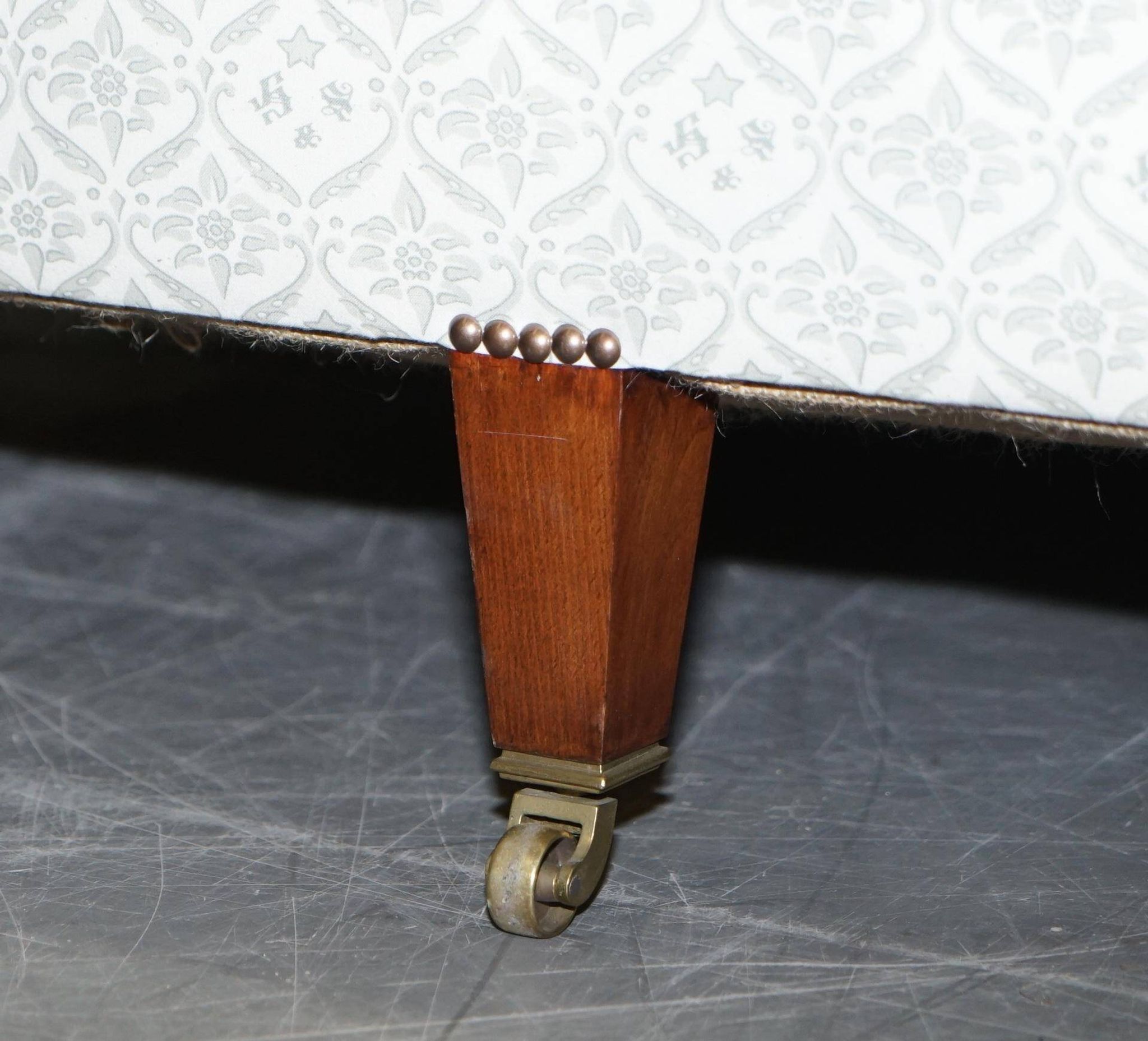 Howard & Sons canapé with feather cushions and ticking fabric, Victorian style.