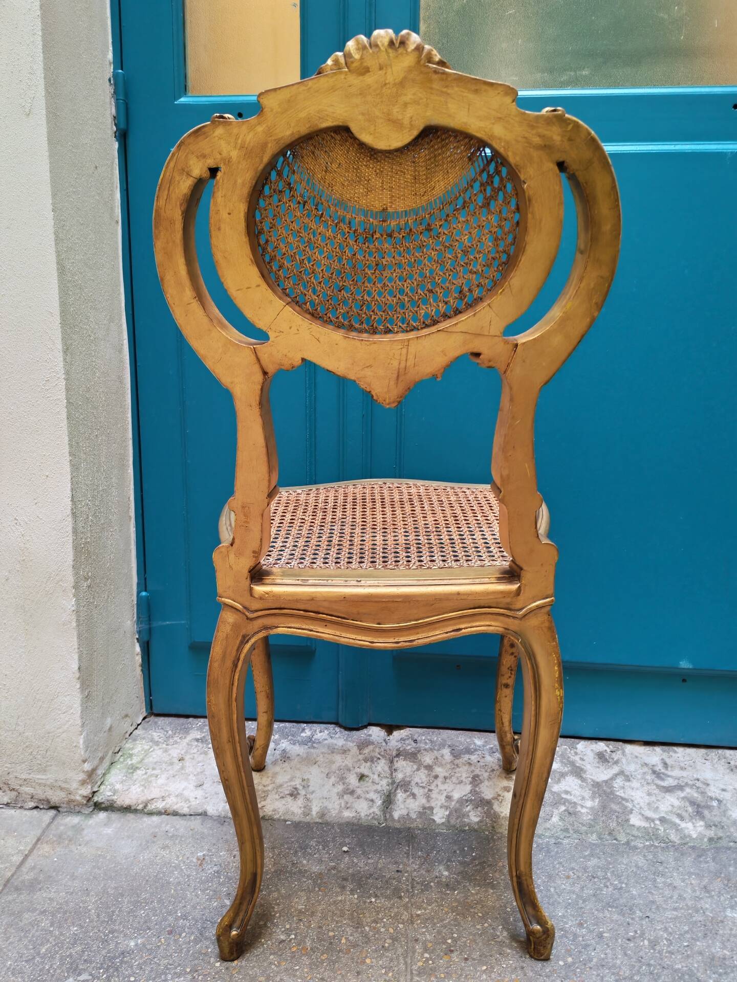 Antique rococo chair in gilded wood and caning