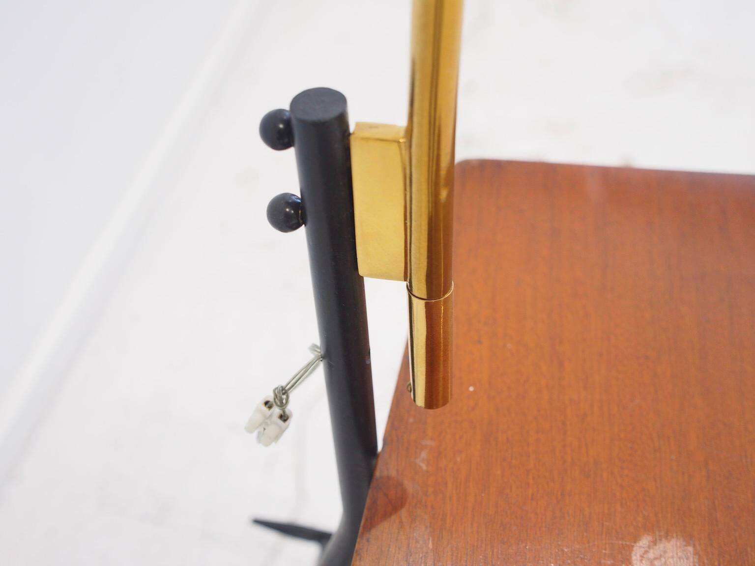 Brass and lacquered metal floor lamp with a wooden magazine shelf.