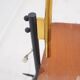 Brass and lacquered metal floor lamp with a wooden magazine shelf.