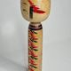Japanese Kokeshi doll dated 1986, signed and numbered, hand-painted multi-colored floral decoration,