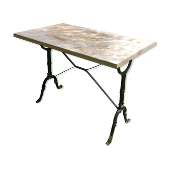 Inlaid bistro table with cases of wine.