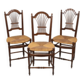 3 wooden and straw chairs, decorated with a sheaf of wheat.