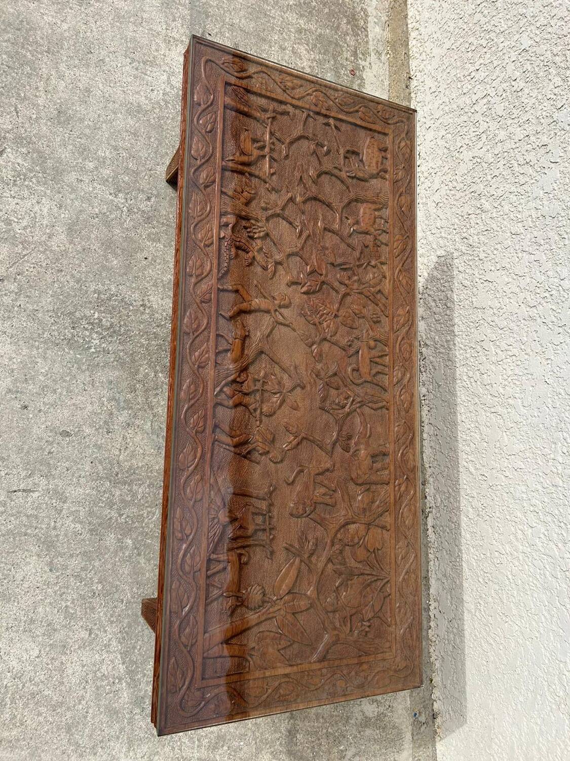 Afro style carved wooden table with glass top