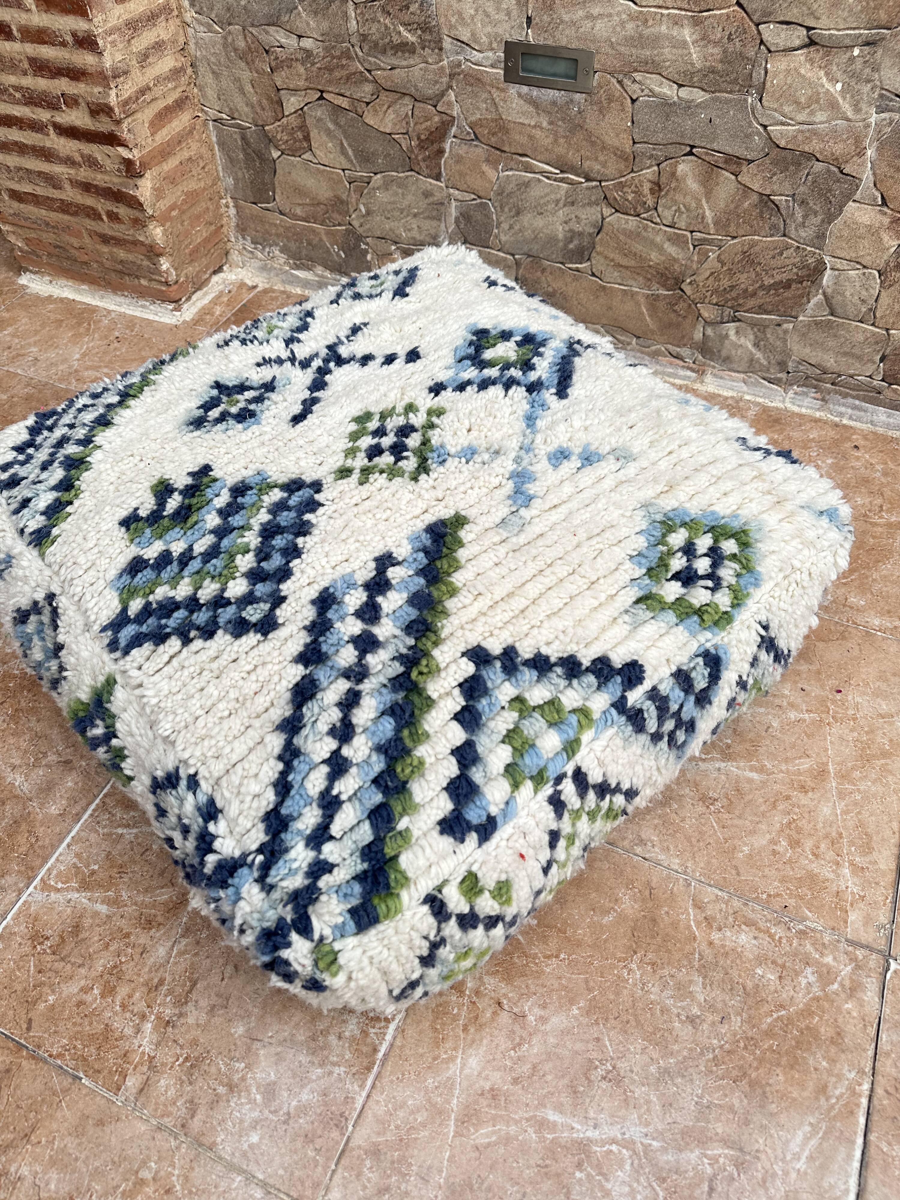 Berber floor pouf: Handwoven Moroccan wool cushion.