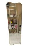 Long trapezoidal mirror in curved gilded brass, art deco modernist