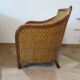 Colonial style armchair in woven rattan and exotic wood