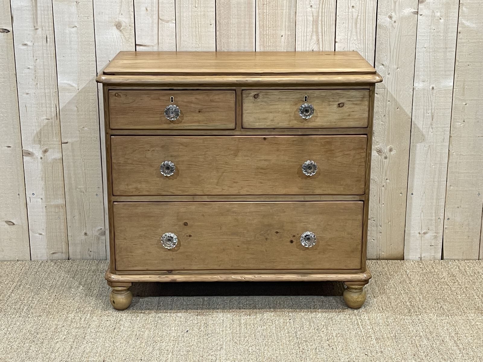 English chest of drawers in nineteenth century fir with its glass buttons