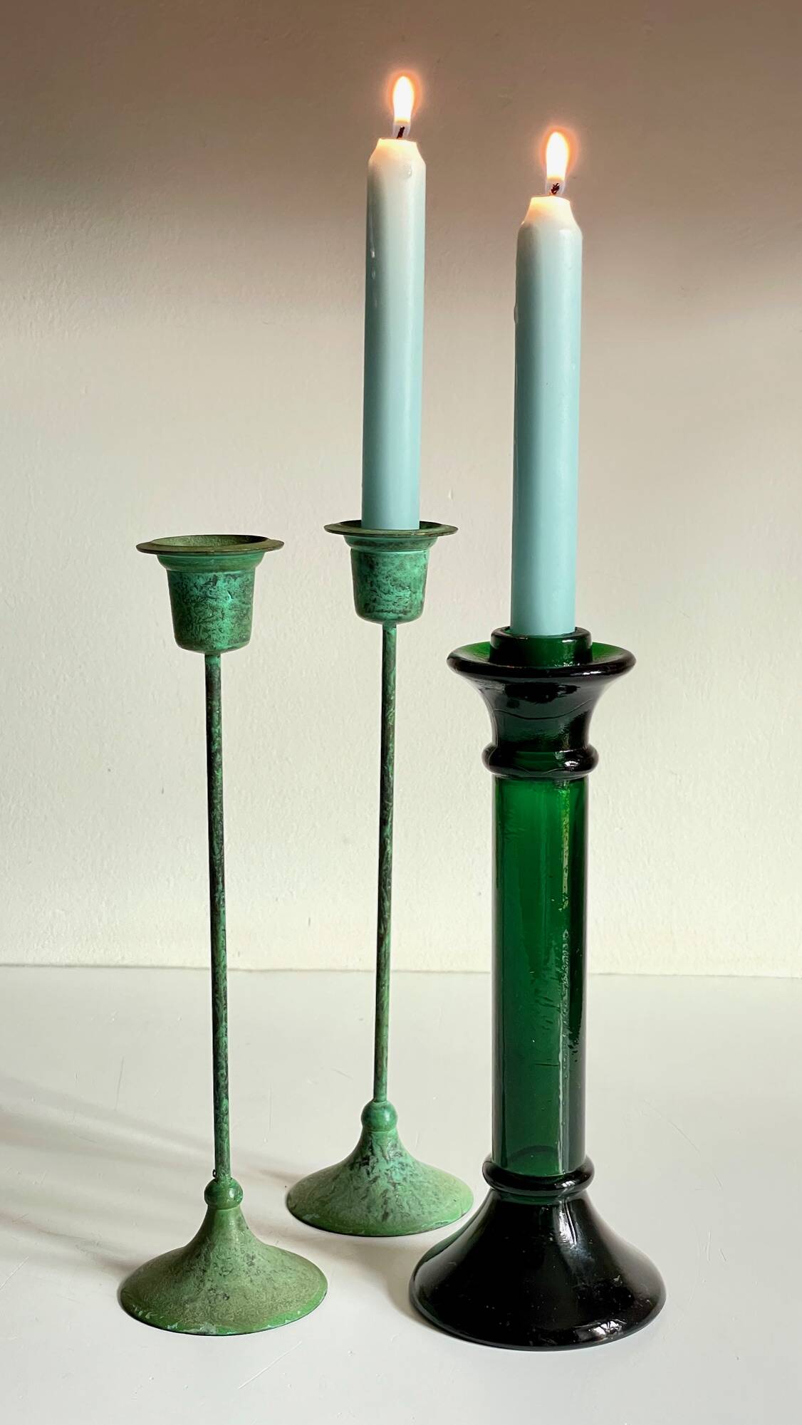 Green glass and metal candle holders