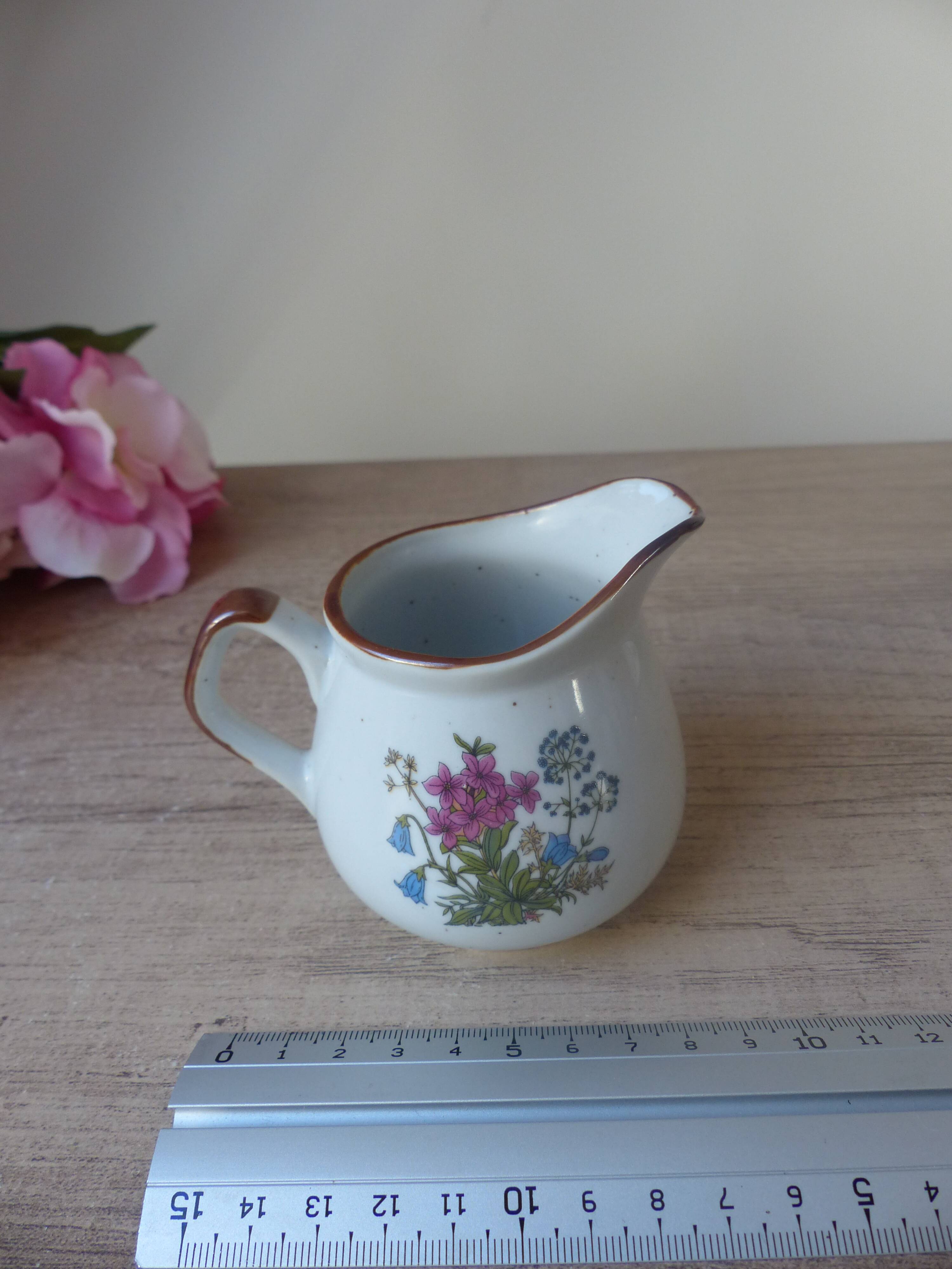 Old small artisanal milk jug in flowered speckled stoneware from the 1980s