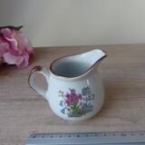 Old small artisanal milk jug in flowered speckled stoneware from the 1980s