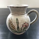 Signed pitcher with thistle decoration