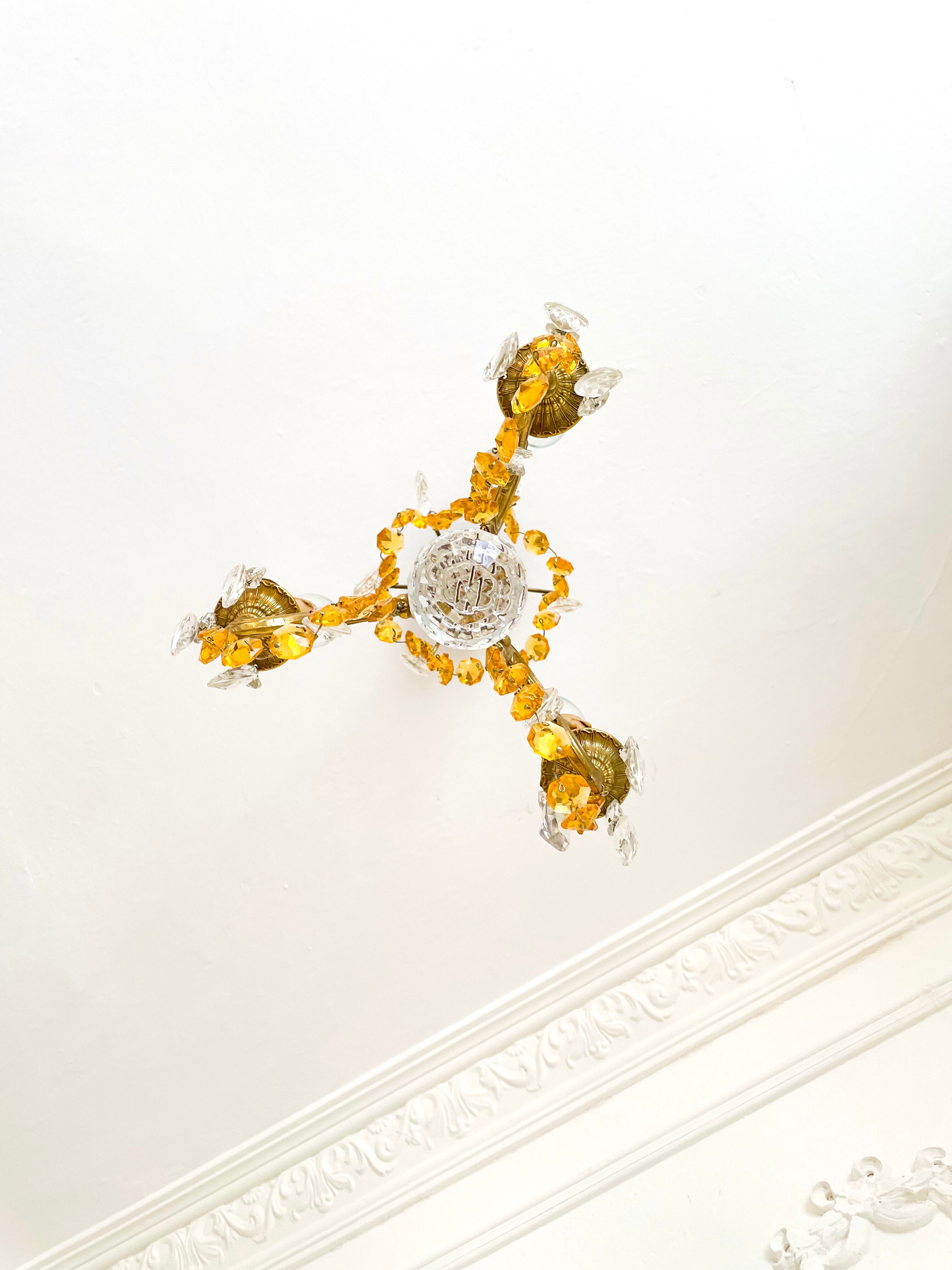 Small vintage brass chandelier with amber crystal pendants.