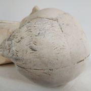 Bust of woman in plaster on pedestal with inscription