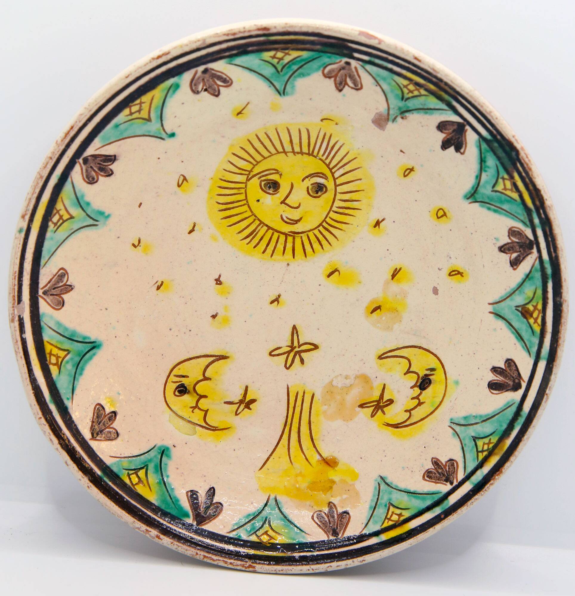 Handmade plate with moon and sun in Romania