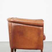 Cognac-colored cow leather club chair finished with decorative nails in English style
