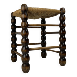 Brutalist wood turned bobbin rush stool in the style of Charles Dudouyt