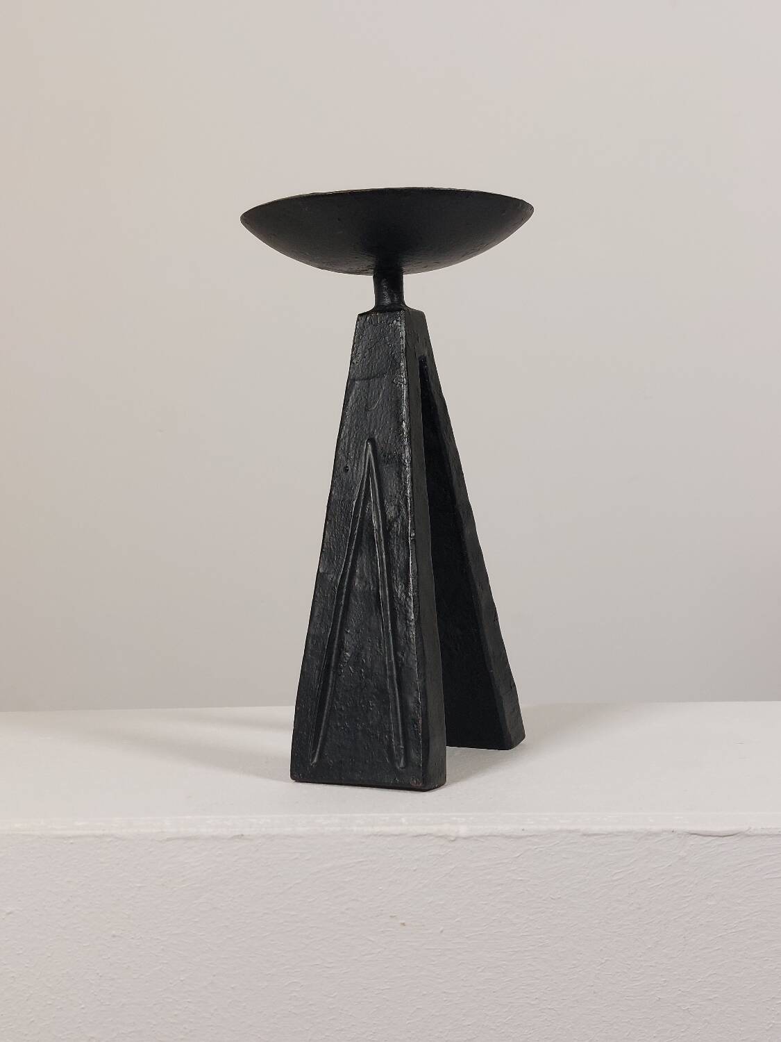 Vintage candle holder made of hand-forged metal, in a brutalist style.