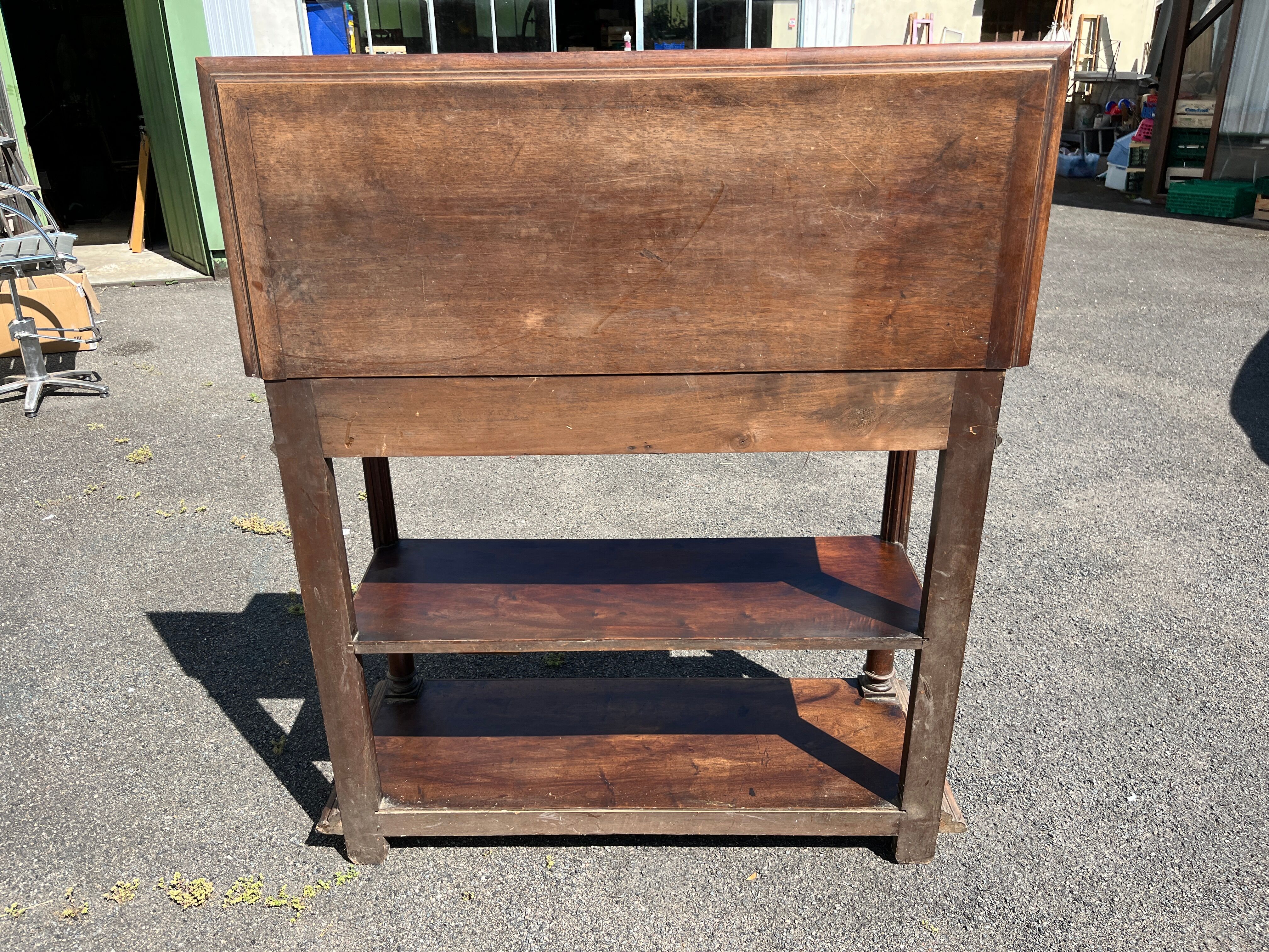 Carved wooden console table with three shelves and drop-leaf flap