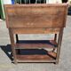 Carved wooden console table with three shelves and drop-leaf flap