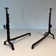 Pair of wrought iron andirons with adjustable supports and tripod feet.
