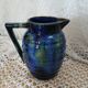 Antique pitcher in enamelled ceramic