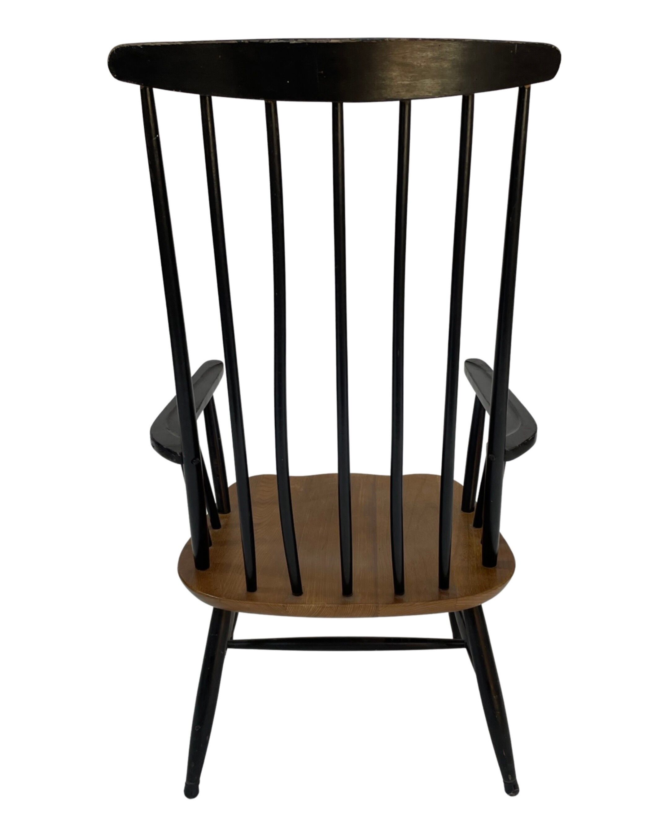 Vintage easy chair with high back and armrest from the 60s
