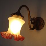 French Art Nouveau wall sconce in bronze with a white and pink glass shade.