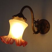 French Art Nouveau wall sconce in bronze with a white and pink glass shade.