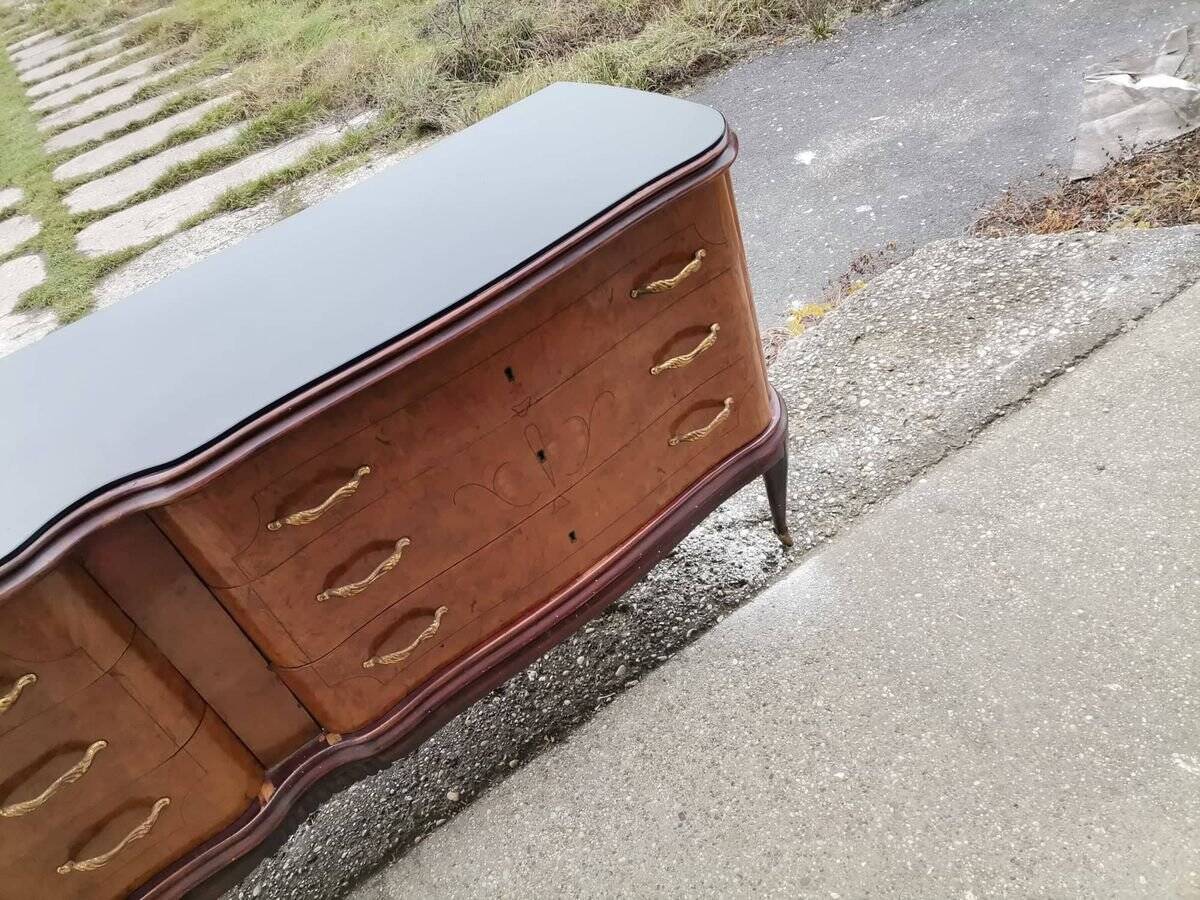 Mid-century Italian brown wooden chest of drawers, black glass top and brass handles.