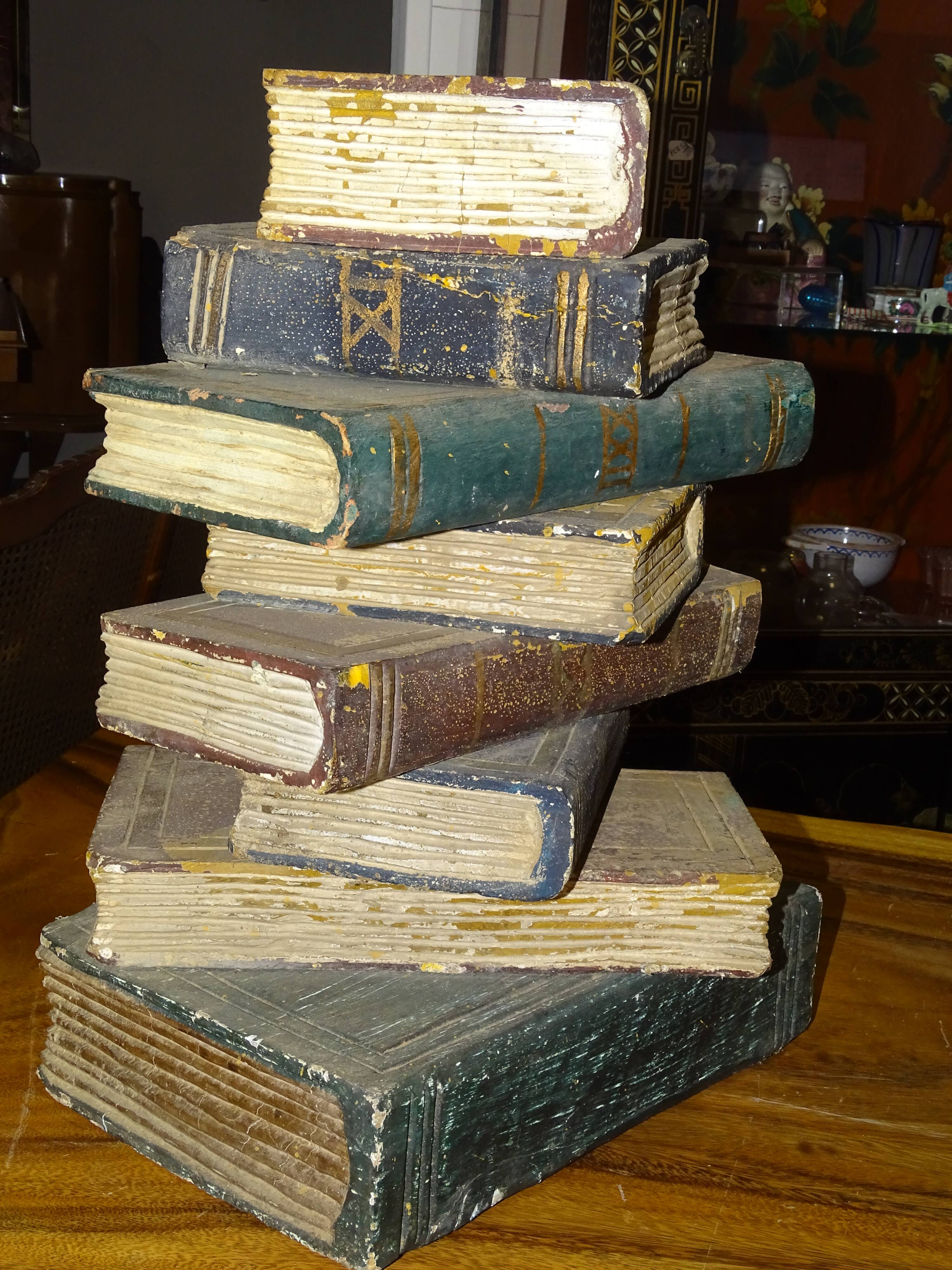 side table, end of sofa stack of wooden books, old, beautiful patina