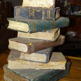 side table, end of sofa stack of wooden books, old, beautiful patina