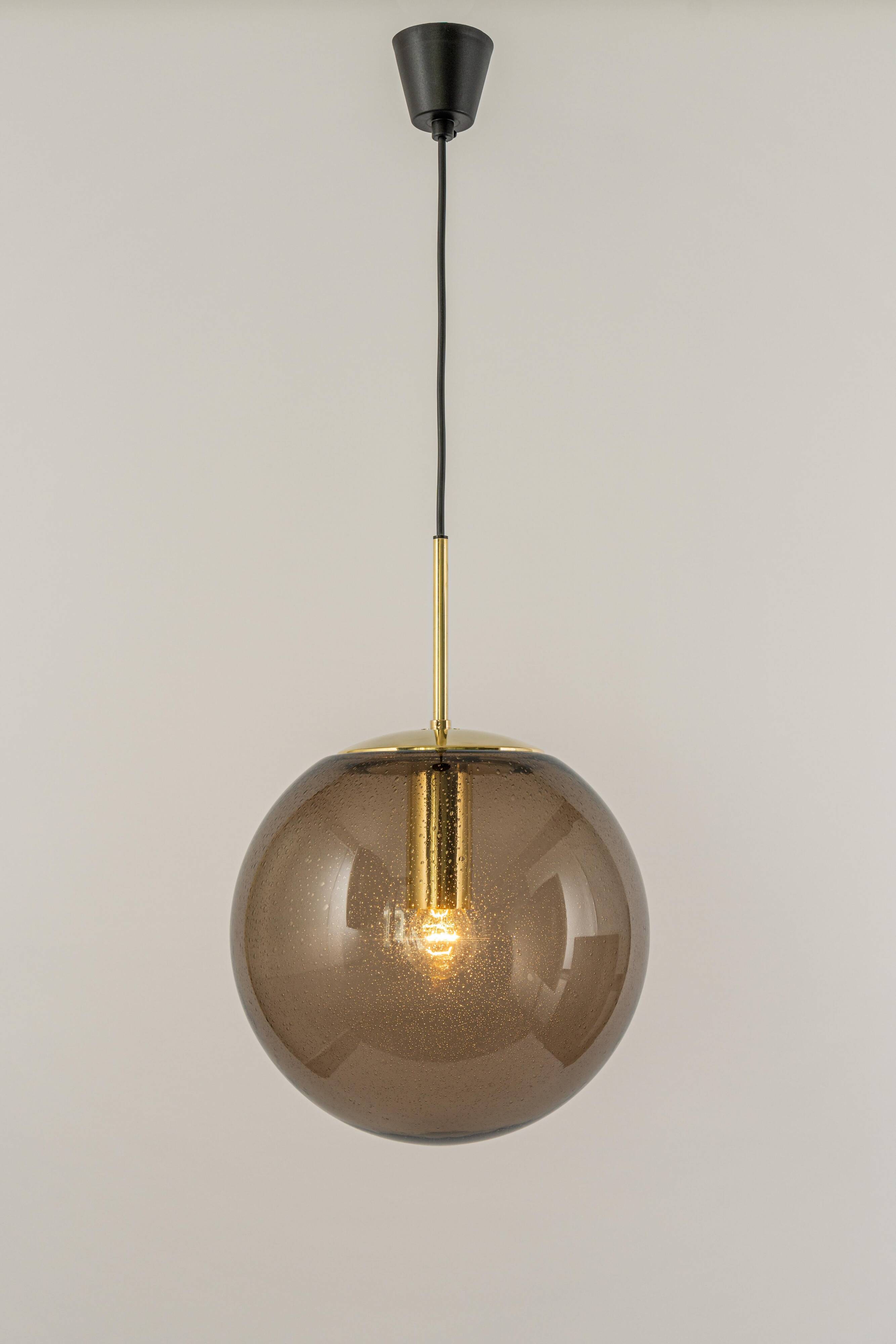Large smoked glass ball pendant by Limburg in brass, Germany, 1970s.