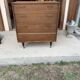Mid-century teak chest of drawers in brown with four drawers, brass handles, 1960s.