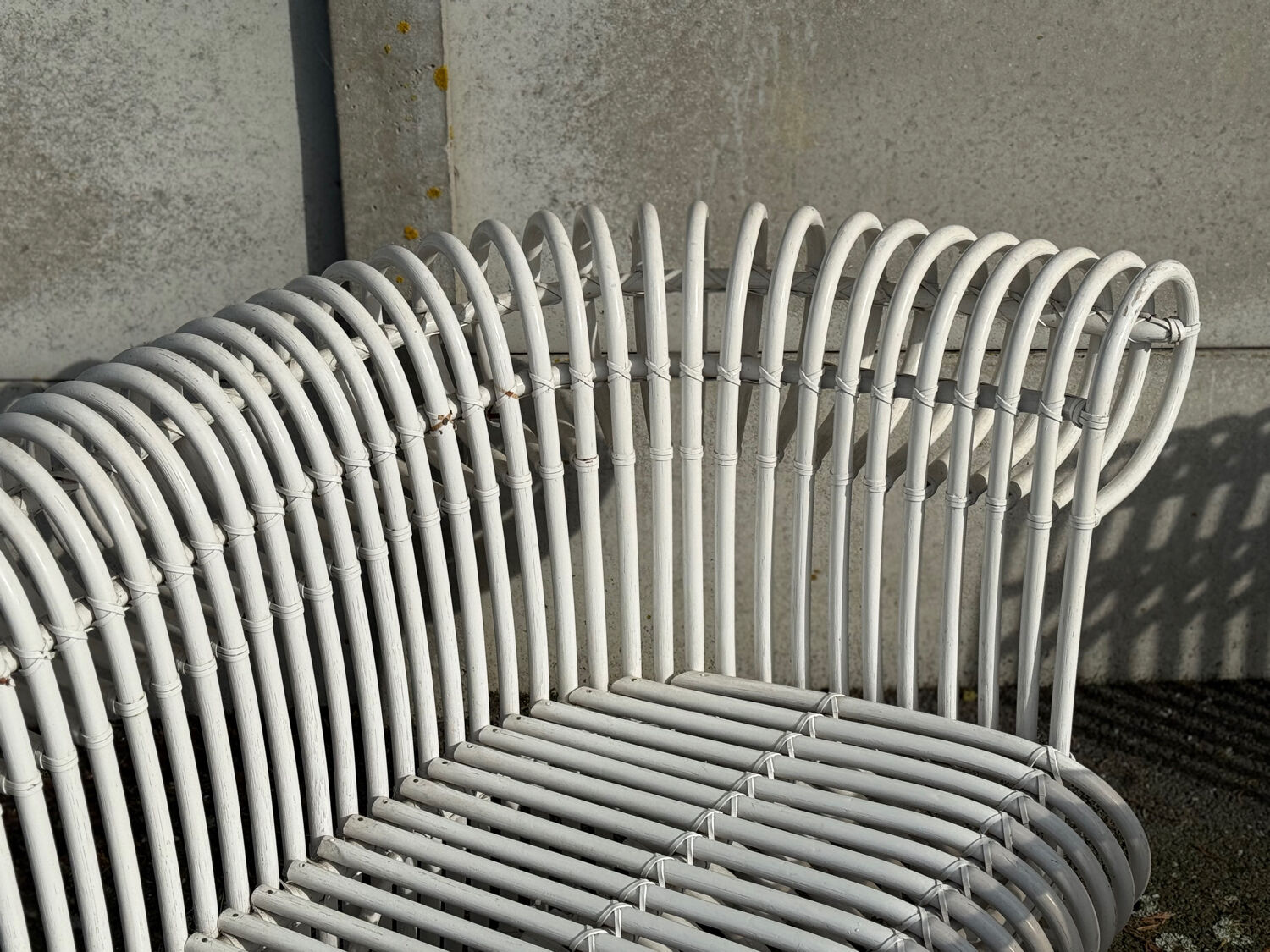 Rattan lounge with two two-seater sofas and a white coffee table.