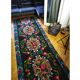 Romanian floral runner rug on blue background