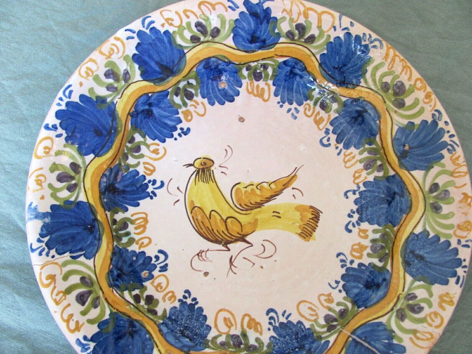 Faience dish decorated with yellow bird on a blue background