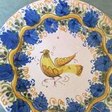 Faience dish decorated with yellow bird on a blue background
