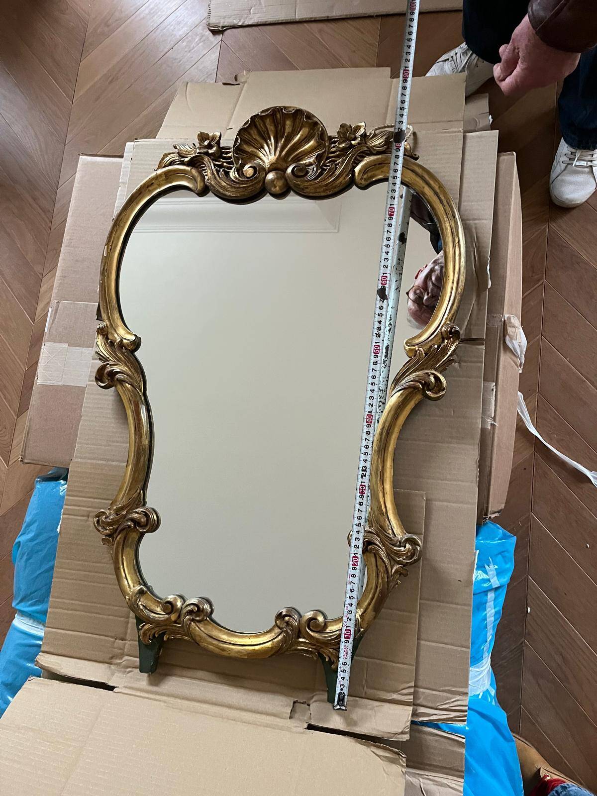 Large wall mirror with a gilded brass frame in Louis XV style.