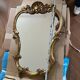 Large wall mirror with a gilded brass frame in Louis XV style.