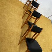 4 Scandinavian chairs in teak and black faux leather.
