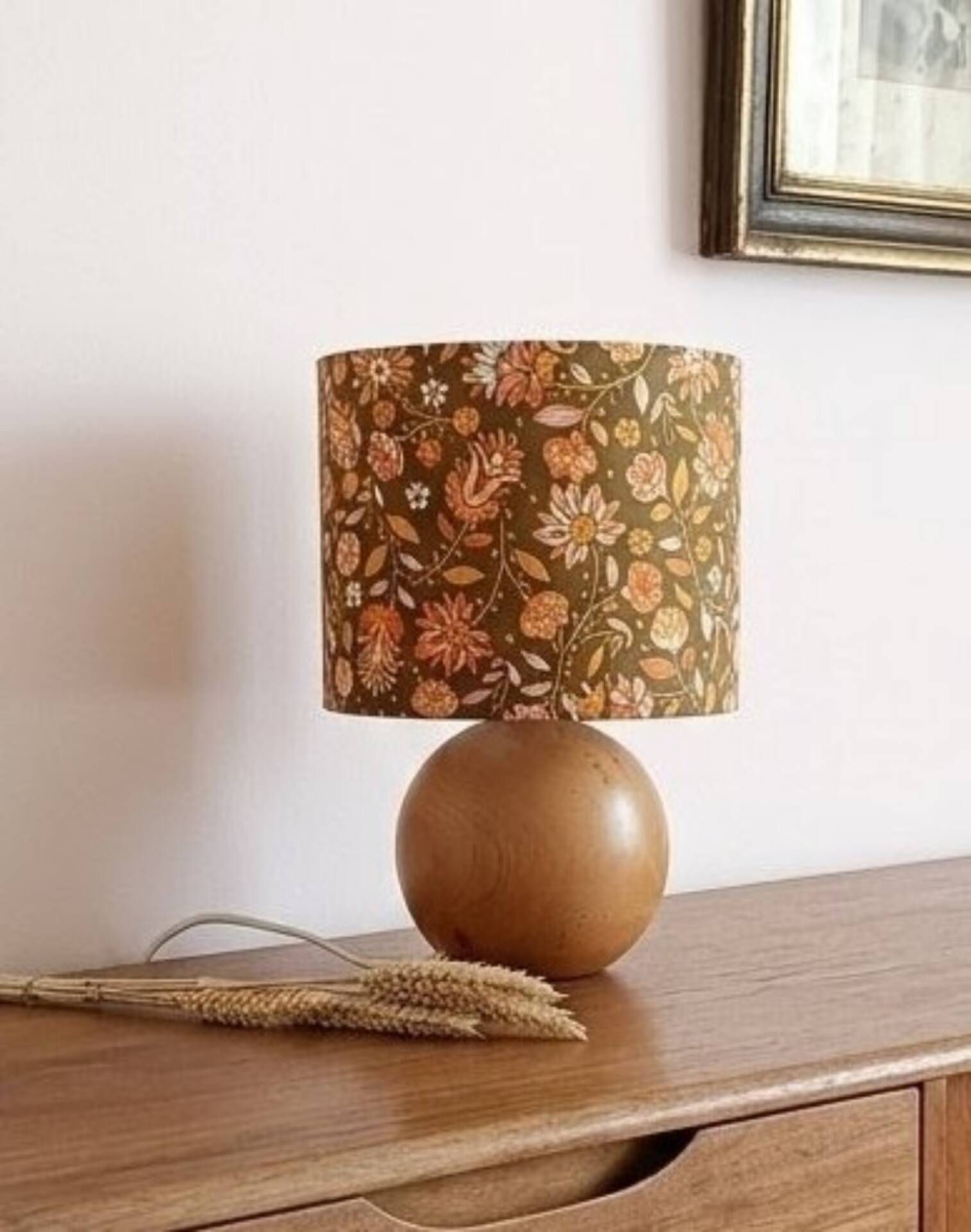 Table lamp with a wooden ball base, floral print in bohemian style.