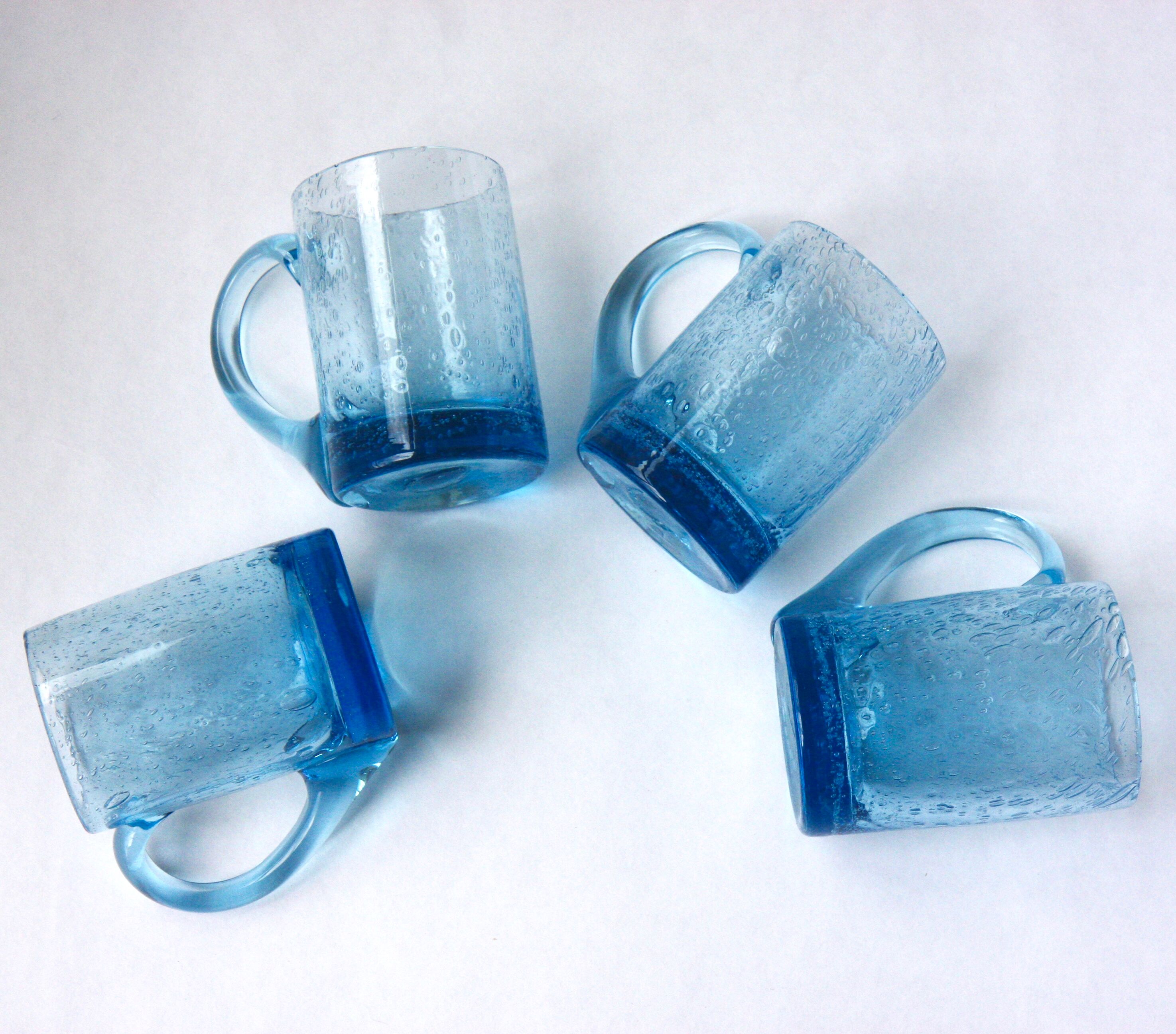 Four Biot glass mugs blue bubbled glass